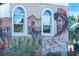 Colorful outdoor mural showcasing local agricultural and nautical scenes with clear windows at 471 Capri Isles Ct, Punta Gorda, FL 33950