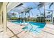 Sparkling screened-in pool with a swan float and comfortable patio area at 471 Capri Isles Ct, Punta Gorda, FL 33950