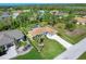 Aerial view of home showing screened pool, landscaping, and proximity to surrounding neighborhood at 5 Pine Valley Rd, Rotonda West, FL 33947