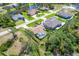 Aerial view of property featuring a private pool surrounded by lush greenery in a peaceful, residential neighborhood at 5 Pine Valley Rd, Rotonda West, FL 33947