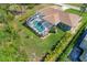 Aerial view of the home showcasing the pool area, fenced backyard, and well-maintained landscaping at 5 Pine Valley Rd, Rotonda West, FL 33947