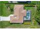 Overhead view of a property with a screened-in pool, manicured lawn, and long driveway in a serene neighborhood at 5 Pine Valley Rd, Rotonda West, FL 33947