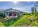 Landscaped backyard featuring a screened-in pool area, perfect for enjoying outdoor living in a private setting at 5 Pine Valley Rd, Rotonda West, FL 33947