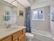 Well-lit bathroom with a single sink vanity, shower-tub combo, and a window at 5 Pine Valley Rd, Rotonda West, FL 33947
