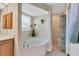 Inviting bathroom featuring a soaking tub, separate shower, and a window offering natural light at 5 Pine Valley Rd, Rotonda West, FL 33947