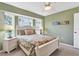 Comfortable bedroom with a queen-sized bed, two nightstands, and a window with a view at 5 Pine Valley Rd, Rotonda West, FL 33947