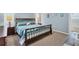 Bedroom showcasing a queen-sized bed, carpet flooring, and ample natural light at 5 Pine Valley Rd, Rotonda West, FL 33947