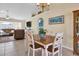 Open dining area with tiled flooring and views of the kitchen and living room at 5 Pine Valley Rd, Rotonda West, FL 33947