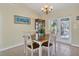 Bright dining area with chandelier, neutral walls, and backyard access at 5 Pine Valley Rd, Rotonda West, FL 33947