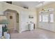 Inviting entryway with tiled floors, white doors, and decorative niche above doorway at 5 Pine Valley Rd, Rotonda West, FL 33947