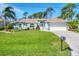 Charming single-story home with well-manicured lawn and beautiful landscaping at 5 Pine Valley Rd, Rotonda West, FL 33947