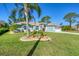 Charming single-story home with well-manicured lawn and beautiful landscaping at 5 Pine Valley Rd, Rotonda West, FL 33947
