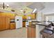 Kitchen featuring light wood cabinets, granite countertops, and tile flooring at 5 Pine Valley Rd, Rotonda West, FL 33947