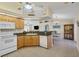 Open-concept kitchen with granite countertops, dishwasher, and breakfast bar at 5 Pine Valley Rd, Rotonda West, FL 33947