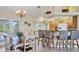 Open-concept kitchen featuring breakfast bar, stainless steel appliances, and adjacent dining area at 5 Pine Valley Rd, Rotonda West, FL 33947