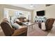 Cozy living room with neutral tones, a ceiling fan, and large window at 5 Pine Valley Rd, Rotonda West, FL 33947