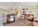 Open-concept living room with dining area and views into kitchen at 5 Pine Valley Rd, Rotonda West, FL 33947