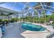 Enclosed pool area with a sparkling pool, patio furniture, and a covered seating area perfect for outdoor relaxation at 5 Pine Valley Rd, Rotonda West, FL 33947