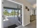 View of enclosed pool area from inside the house with view of lake beyond at 5 Pine Valley Rd, Rotonda West, FL 33947