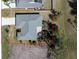 Bird's eye view of house, lawn, mature trees, and a long driveway at 51 Mark Twain Ln, Rotonda West, FL 33947