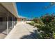 Exterior view of the home with a screened lanai, a well-manicured lawn, and mature landscaping at 51 Mark Twain Ln, Rotonda West, FL 33947