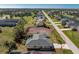 Aerial view of home with a lawn, and a lot beside it with soil at 51 Mark Twain Ln, Rotonda West, FL 33947