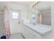 Bathroom featuring a sink vanity, large mirror and shower at 51 Mark Twain Ln, Rotonda West, FL 33947