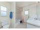 Bright bathroom with a bathtub, toilet and sink vanity at 51 Mark Twain Ln, Rotonda West, FL 33947