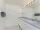 Bathroom with double sinks and vanity with tile floors and neutral wall color at 51 Mark Twain Ln, Rotonda West, FL 33947