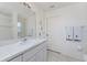 Bathroom featuring a sink vanity, large mirror and shower at 51 Mark Twain Ln, Rotonda West, FL 33947