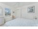 Bright bedroom with a ceiling fan, large windows and closet doors at 51 Mark Twain Ln, Rotonda West, FL 33947