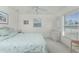 Bright bedroom with a ceiling fan, large windows, and stylish furnishings at 51 Mark Twain Ln, Rotonda West, FL 33947