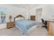 Cozy bedroom featuring natural light from the window, complemented by rattan furniture and soft carpet at 51 Mark Twain Ln, Rotonda West, FL 33947