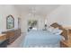 Bright bedroom featuring a ceiling fan, and sliding door access to the patio at 51 Mark Twain Ln, Rotonda West, FL 33947