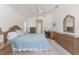 Bedroom with natural lighting, ceiling fan, and warm decor and carpet create a tranquil retreat at 51 Mark Twain Ln, Rotonda West, FL 33947