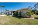 Well-maintained home with lush landscaping, a two-car garage, and a welcoming front yard at 51 Mark Twain Ln, Rotonda West, FL 33947