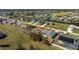 The single-story house has a lawn, landscaping, and is near a community canal at 51 Mark Twain Ln, Rotonda West, FL 33947