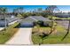 Charming single-story home with a well-manicured lawn and a spacious two-car garage at 51 Mark Twain Ln, Rotonda West, FL 33947