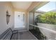 Inviting front porch with a comfortable bench and a decorative front door with glass panels at 51 Mark Twain Ln, Rotonda West, FL 33947