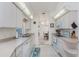 Well-lit kitchen featuring white appliances, light countertops and tile floor; flows to the dining area at 51 Mark Twain Ln, Rotonda West, FL 33947