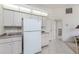 Bright kitchen featuring white cabinets and tile flooring, offering a clean and spacious area at 51 Mark Twain Ln, Rotonda West, FL 33947