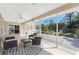 Spacious screened lanai offering an outdoor living area with a ceiling fan and view of the backyard at 51 Mark Twain Ln, Rotonda West, FL 33947