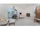 Inviting living room with large windows, cozy seating, and neutral decor at 51 Mark Twain Ln, Rotonda West, FL 33947
