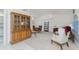 Spacious living and dining room with neutral carpeting, white walls, and a large hutch at 51 Mark Twain Ln, Rotonda West, FL 33947