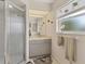 Clean bathroom with a glass shower, neutral vanity, and a window for natural light at 5258 Grassland Ter, Port Charlotte, FL 33981