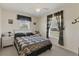 Cozy bedroom with patterned curtains, ceiling fan, and a neatly made bed at 5258 Grassland Ter, Port Charlotte, FL 33981