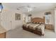 Well-lit bedroom with a large bed, ceiling fan, and light-colored walls at 5258 Grassland Ter, Port Charlotte, FL 33981