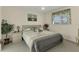 Bright bedroom with soft, neutral decor, and a large window for natural light at 5258 Grassland Ter, Port Charlotte, FL 33981