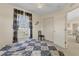Bedroom with a patterned bed, large window, and an adjacent closet and doorway at 5258 Grassland Ter, Port Charlotte, FL 33981