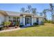 A beautiful home showcases neat landscaping, adding to its curb appeal, and a well-maintained lawn at 5258 Grassland Ter, Port Charlotte, FL 33981